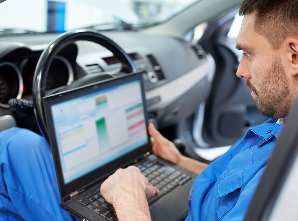 Mechanic diagnosing a vehicle using a computer - Car Diagnostics Southampton