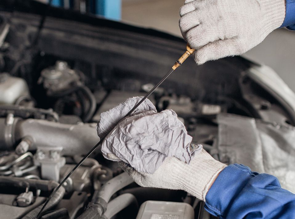 Mechanic changing vehicle engine oil - Car Servicing Southampton